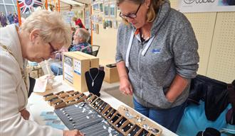 Woman looking at jewelery pop up store