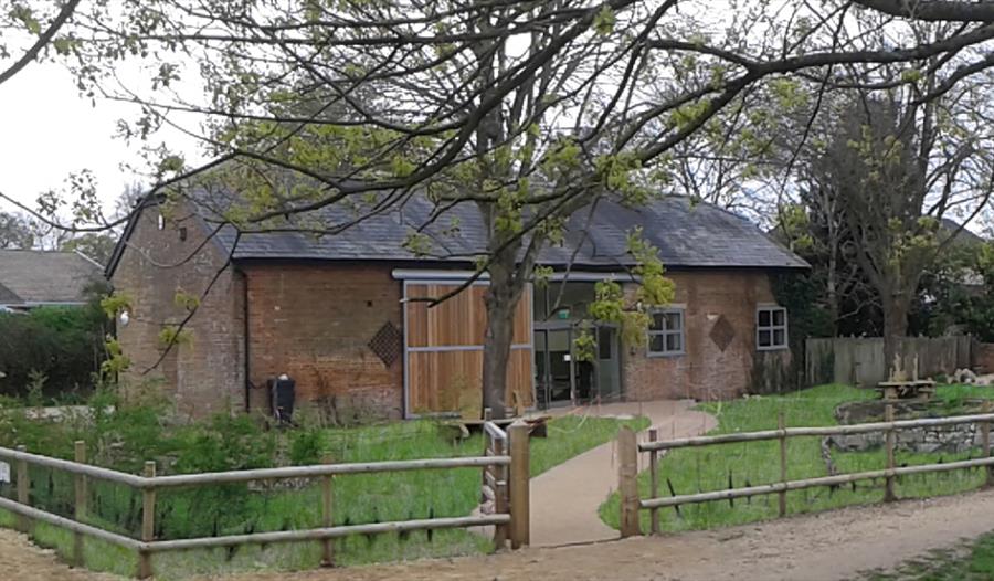photo of Kingfisher Barn Visitor Centre with trees and garden