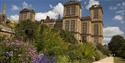 Hardwick Hall with purple flowers in front and blue skies