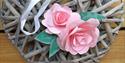 Pink paper roses on a wicker wreath