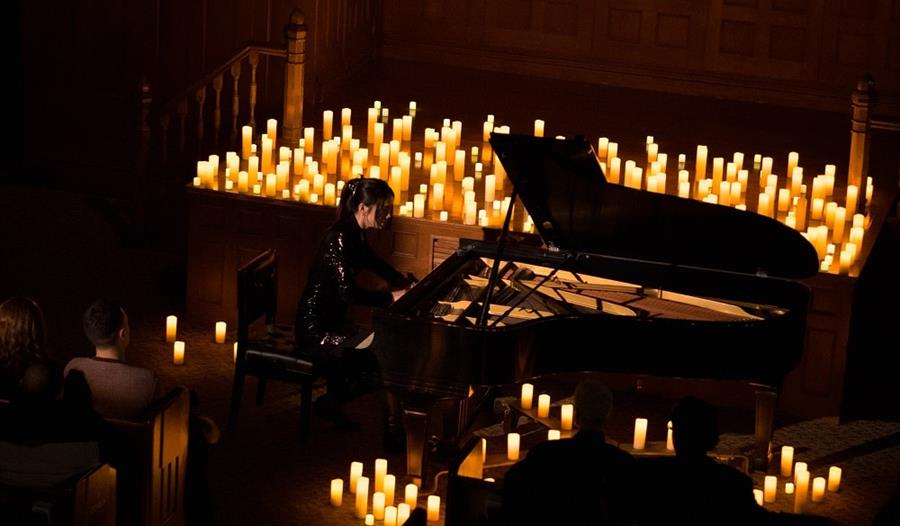 Piano surrounded with candles