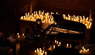 Piano surrounded with candles