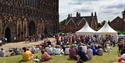 Crowds enjoy an outdoor performance in front of Lichfield Cathedral