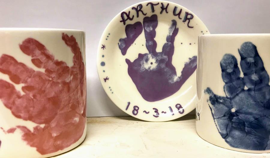 Little hand and footprints on mugs and plates