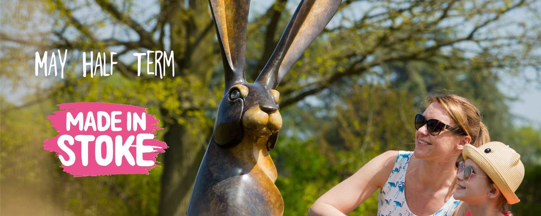 Image of mother and daughter looking at rabbit statue