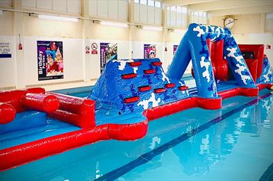Take on the inflatable aqua run at New Horizons