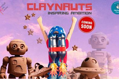 A rose-tinted sky as the background with objects made of clay such two robots, two spaceships and a person with a jetpack with flames emanating from i