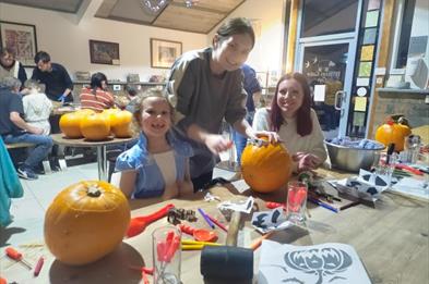 Family carving pumpkins.