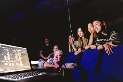 Photo of people looking at a laptop