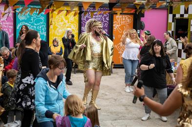 Crowd watching a street performer at a festival.