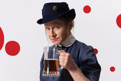Photo of nurse holding a pint.