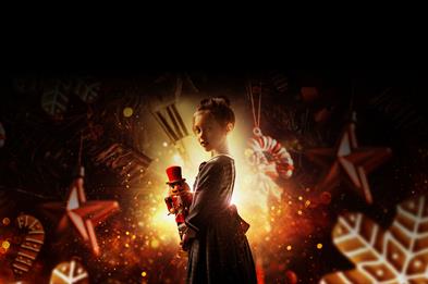 Young girl holding a nut cracker doll