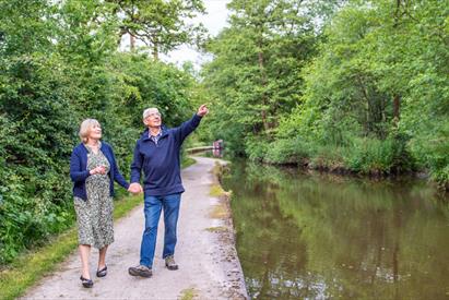 A couple walking along the Caldon Canal (near Cheddleton Flint Mill)