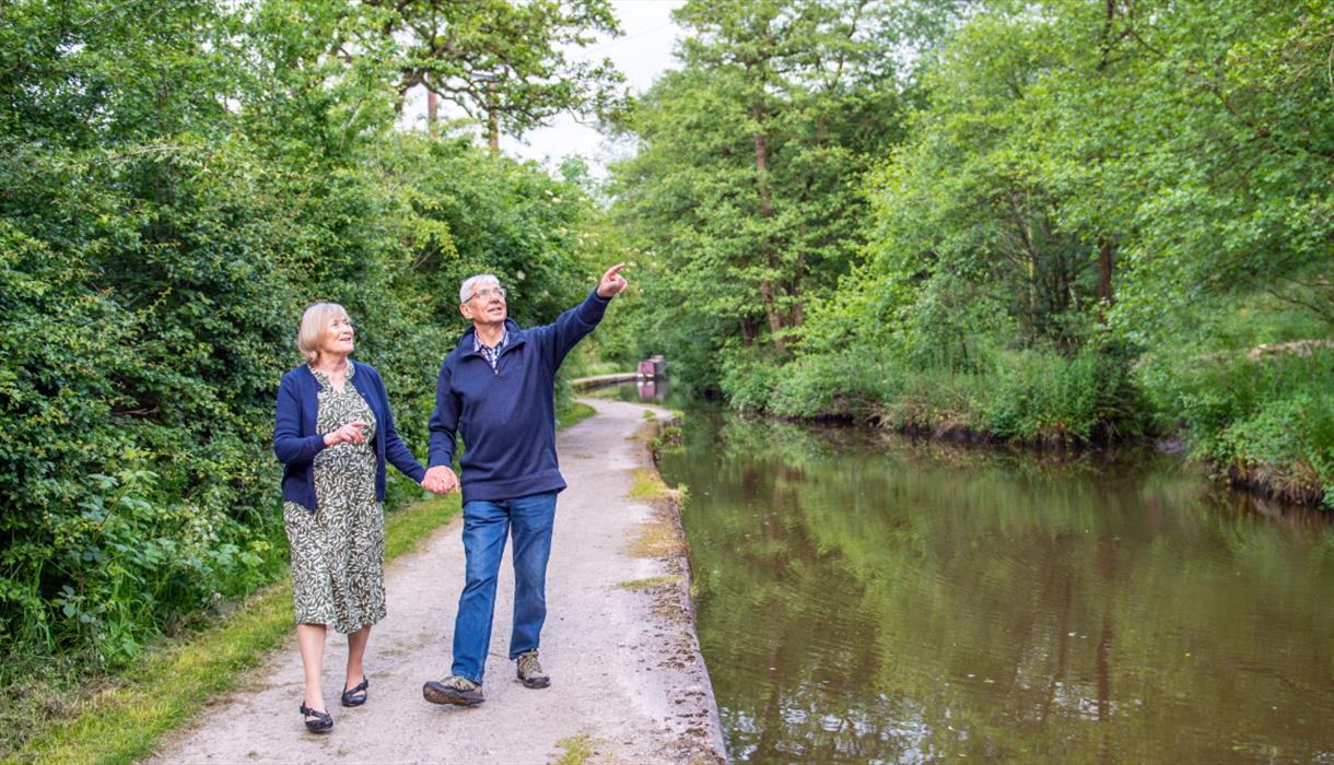 A couple walking along the Caldon Canal (near Cheddleton Flint Mill)