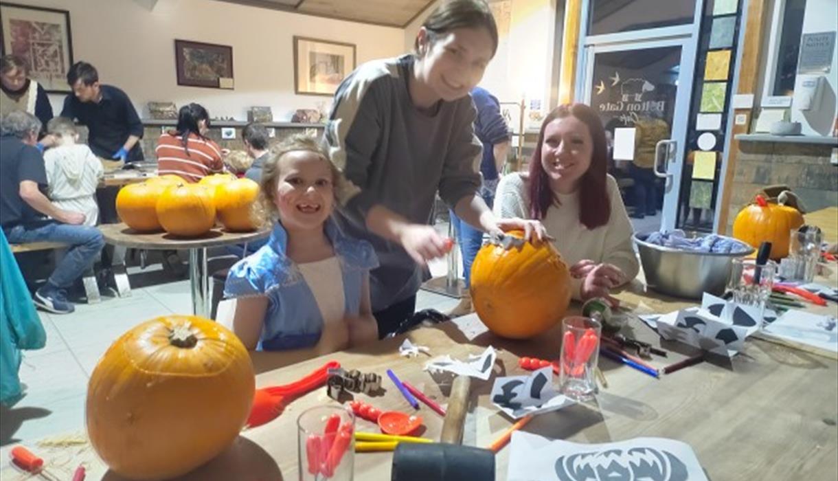 Family carving pumpkins.
