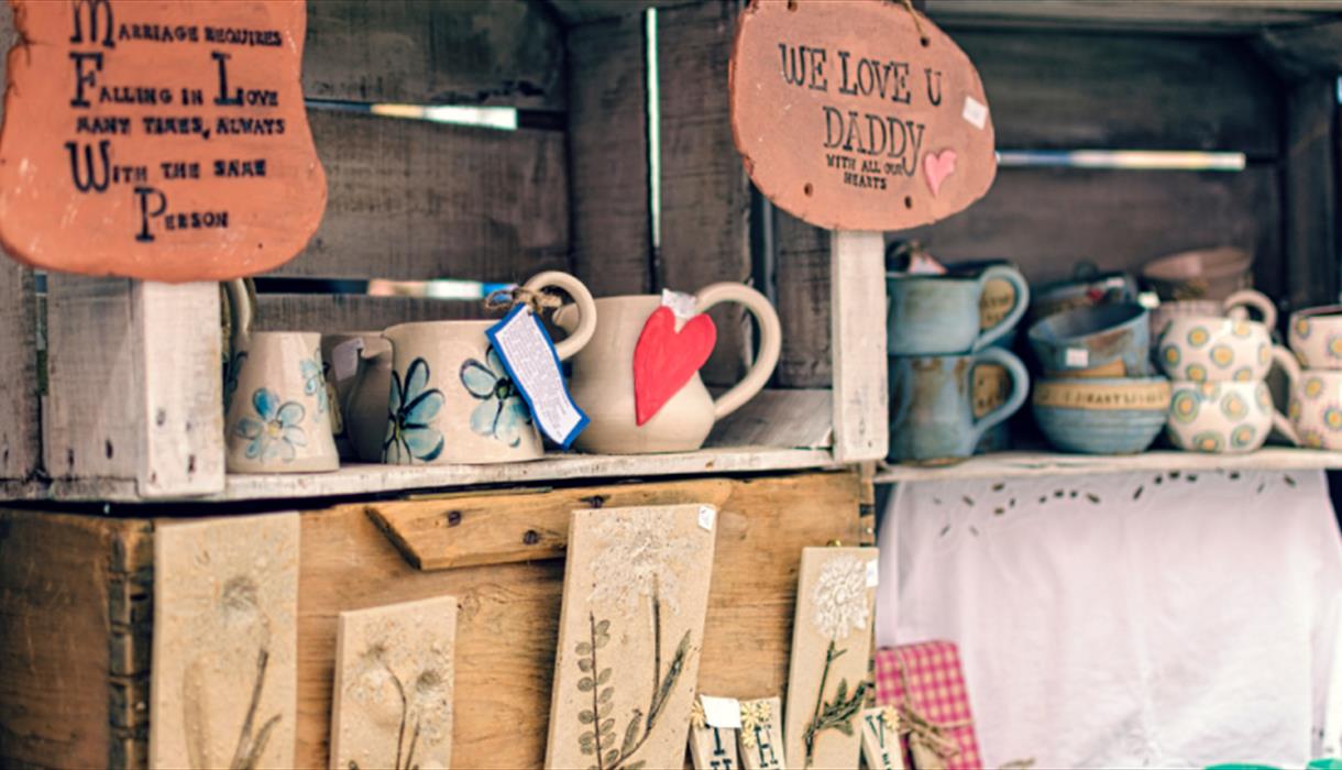 Image of a pottery stall at a market.