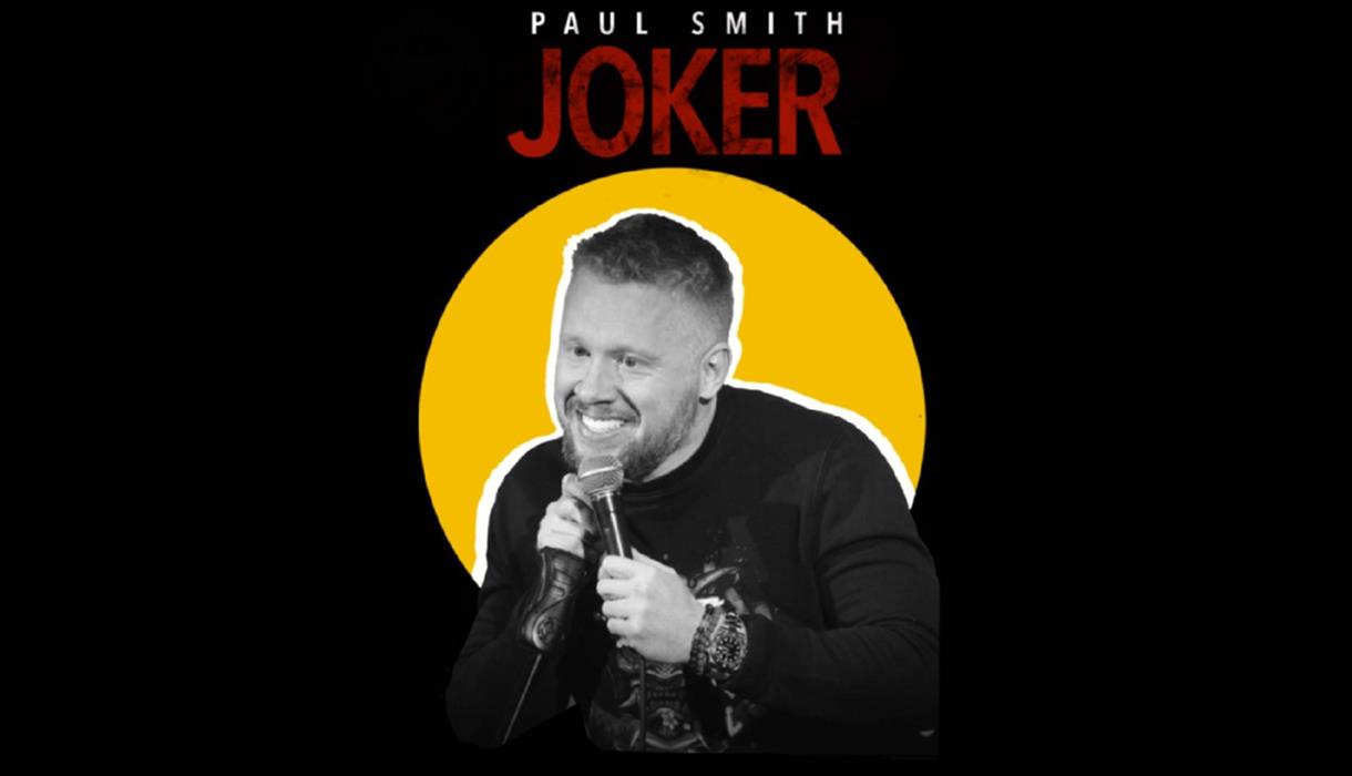 Image of Paul Smith holding a microphone.