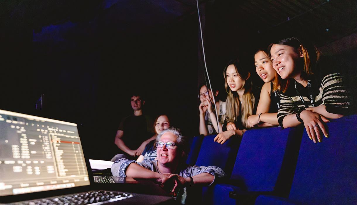 Photo of people looking at a laptop