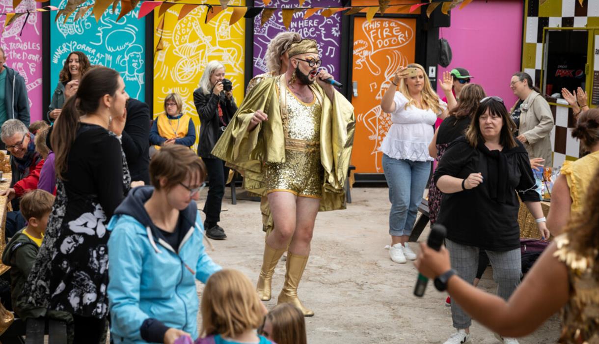 Crowd watching a street performer at a festival.