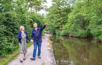 A couple walking along the Caldon Canal (near Cheddleton Flint Mill)