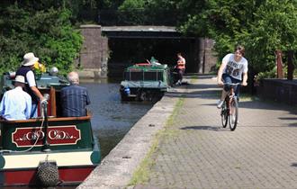 Cyclist and boaters on the Trent & Mersey Canal