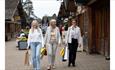Friends walking through the Trentham Shopping Village.