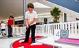 A young visitor enjoys some crazy golf