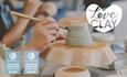 A close-up image of a visitor painting an up-turned bowl or cup