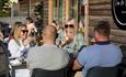 Friends enjoying a drink outside at one of the restaurants at Trentham Shopping Village.