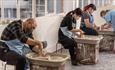 Visitors throwing a pot at World of Wedgwood Creative Studios