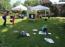 Families enjoying craft activities outside at Watts Gallery