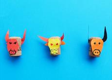 Three minotaurs made from a cork and coloured paper