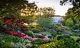 View across the Rock Garden towards the Glasshouse at RHS Garden Wisley. Credit: RHS / Jason Ingram
