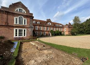 Archaeological dig in front of historic house