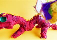 A dragon sculpture made with red fabric and feathers