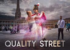 The two famous characters from the Quality Street dance in a gloomy scene, there are members of the public looking surprised as they go about their bu