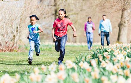 Children running through the gardens at Polesden Lacey