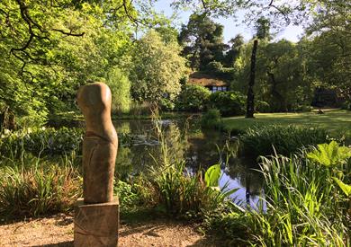 The Hannah Peschar Sculpture Garden - 'Woodland Torso' Paul Vanstone, evening light at Black & White Cottage