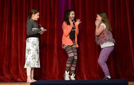 Guildford Shakespeare Company Drama Club students pictured smiling and jumping during their showcase performance