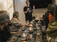 A host arranging a brewery visit looking towards a group of guests