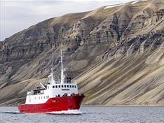 A boat sailing along a mountain range