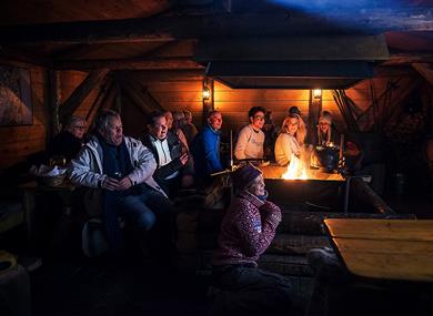 Guests listening to a lecture inside the cabin at Camp Barentz