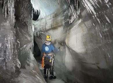 A person inside an ice cave