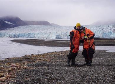 Two guests with a glacier in the background