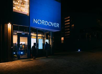 Persons outside the entrance door to Nordover