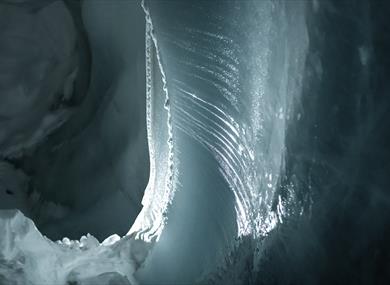 Ice formations inside a dark ice cave