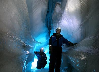 Two people in an ice cave