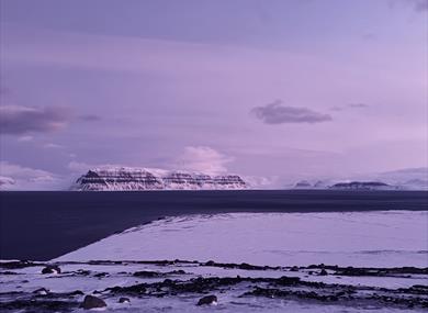 Image of the fjord with mountains in the background
