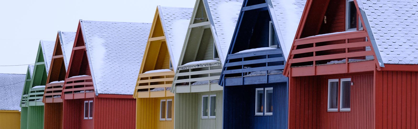 Colourful houses with snow-covered roofs