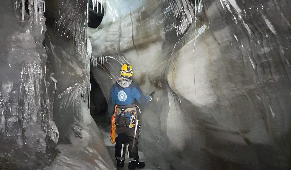 A person inside an ice cave